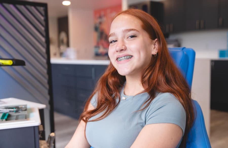 teen patient smiling with braces on